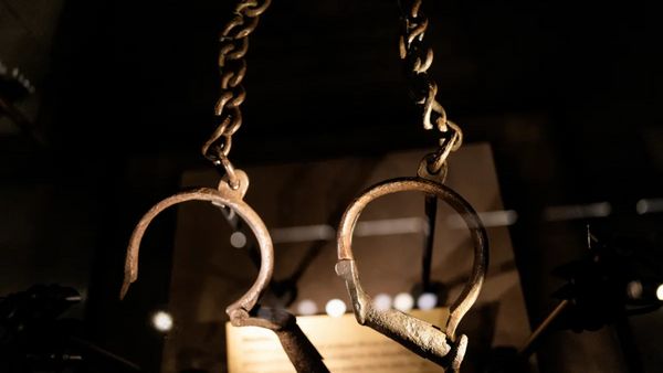 A pair of what appear to be handcuffs hang down.