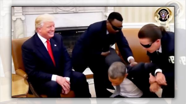 A white man sitting in a chair smiles as a Black man appears to be arrested by two other men wearing dark blue suits.