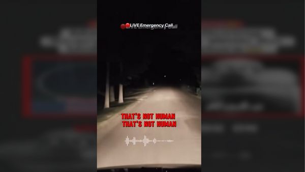 Screenshot from TikTok video with 911 call audio. Shows a nighttime dashcam on a dirt road with the text "LIVE Emergency Call" and "THAT'S NOT HUMAN THAT'S NOT HUMAN"
