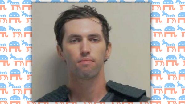A mugshot of a young white man with short brown hair. In the backdrop is a patterned graphic design of small Republican elephant logos and Democrat donkey logos. 