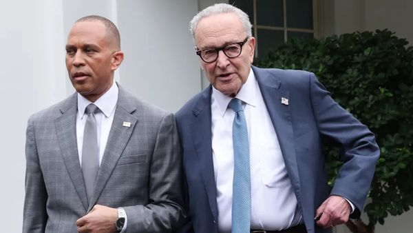 U.S. House Minority Leader Hakeem Jeffries, a Black, bald man in a grey suit, and Senate Minority Leader Charles Schumer, an older white man in a navy suit, leave the White House. man wearing a blue suit.