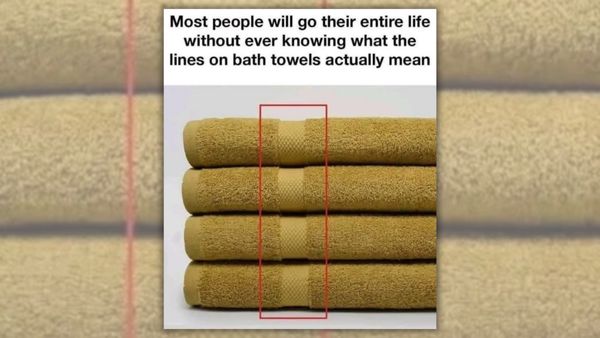 A picture of yellow towels with a red rectangle highlighting the woven strip within the towel. The words above the picture read, "Most people will go their entire life without ever knowing what the lines on bath towels actually mean"
