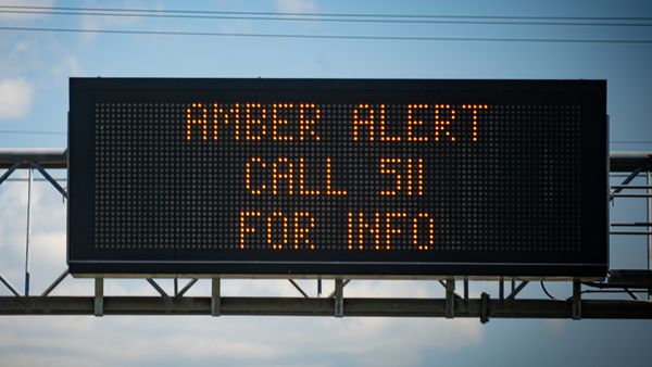An image shows an Amber Alert sign on a highway, issued when a child goes missing and is believed to be abducted.