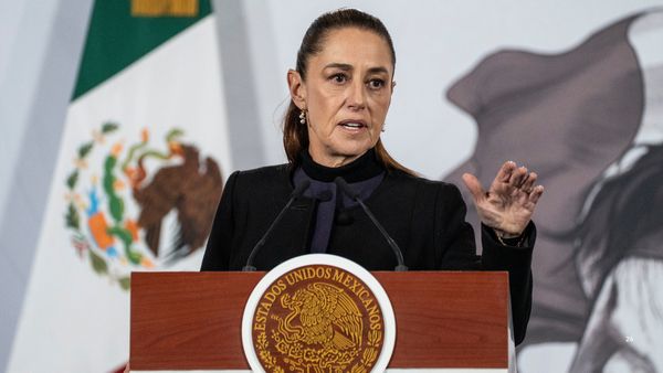 Mexico President Claudia Sheinbaum, a Latina wearing a dark outfit, gestures as she speaks during a daily morning briefing at Palacio Nacional on Feb. 23, 2026 in Mexico City, Mexico.