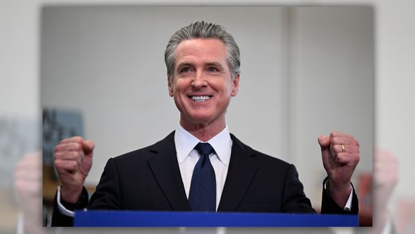 An image shows California Governor Gavin Newsom grinning.