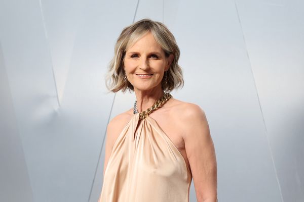 Helen Hunt, a white woman wearing a dress, attends the 2026 Vanity Fair Oscar Party. 