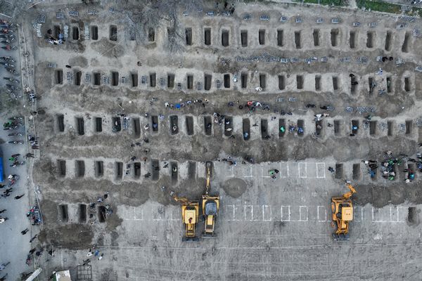 In this image, mourners dig graves during the funeral for children killed in a reported strike on a primary school in Iran's Hormozgan province in Minab on March 3, 2026.