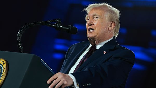 U.S. President Donald Trump speaks at a podium at a National Republican Congressional Committee fundraising dinner on March 25, 2026.