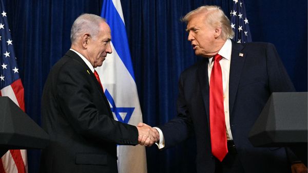 This image shows U.S. President Donald Trump and Israeli Prime Minister Benjamin Netanyahu shaking hands.
