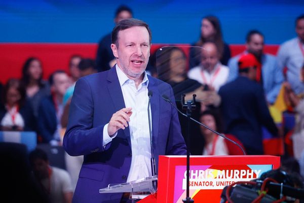 Image shows U.S. Sen. Chris Murphy, a white man with brown hair, giving a speech.