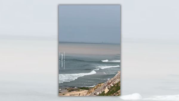 Screenshot from video claiming sewage dam was opened into Gaza water. It's an image of the ocean from the vantage point of a dune or cliff. While the nearby water is bluish, the more distant water is brown.