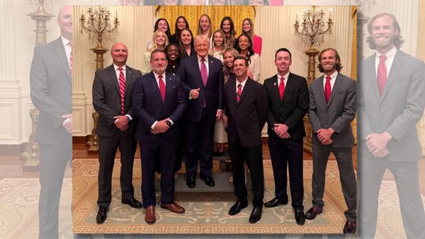 Image shows U.S. President Donald Trump standing in front of members of the University of Georgia women's tennis team. 