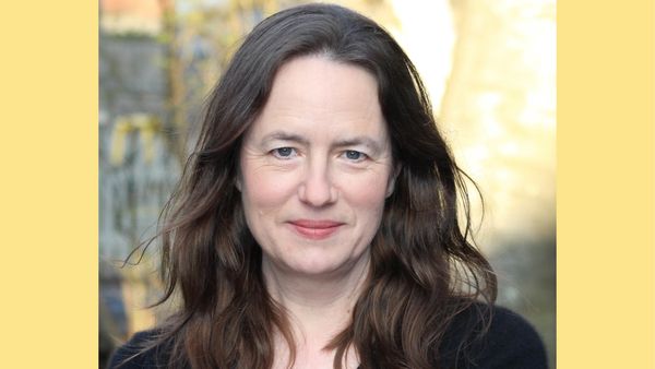 A shoulders-up image of Heather Cox Richardson, a middle-aged white woman with long, dark brown hair. 