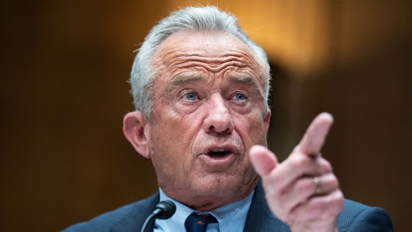Robert F. Kennedy, Jr., an old white man with gray-white hair, points his finger at someone while talking into a microphone.