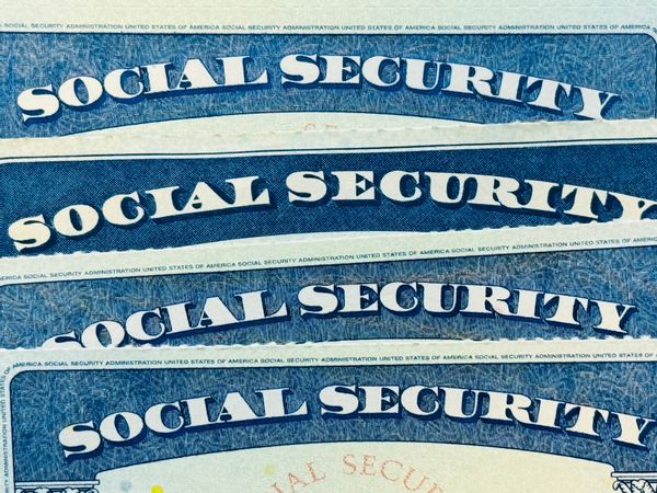 Image shows Social Security cards.