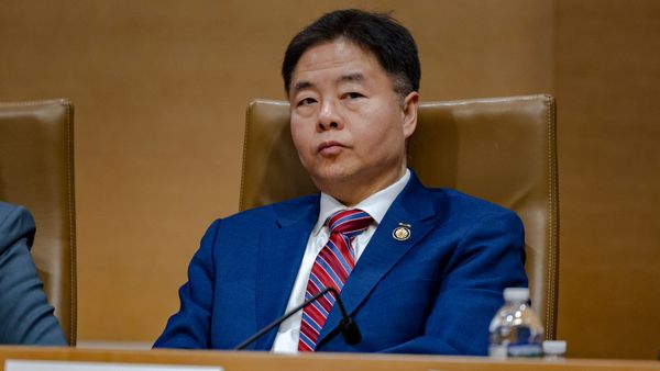 Image shows U.S. Rep. Ted Lieu seated behind a desk.