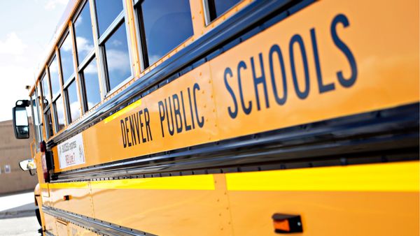 Photo shows the side of a yellow school bus with the text "Denver Public Schools."