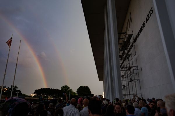 Photograph shows a double rainbow alongside the Kennedy Center in Washington D.C. 