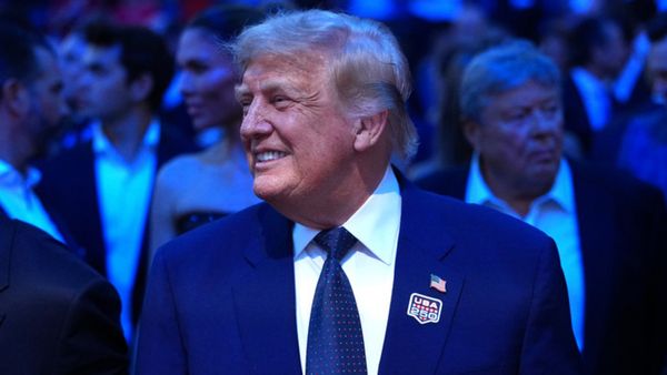 President Donald Trump in a blue suit within a crowd. 
