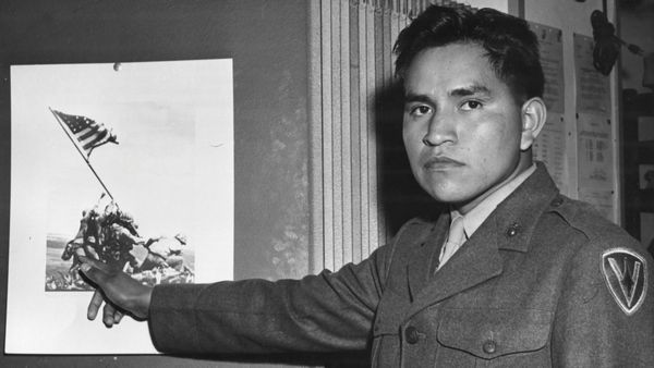 WWII veteran and Pima Indian Ira Hayes pointing at Joe Rosenthal's famous photo of Hayes and five other service members raising the U.S. flag at Iwo Jima.