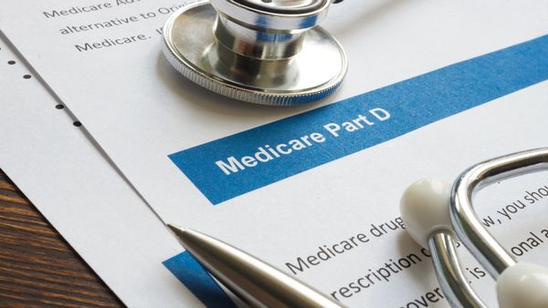 Stock image of a stethoscope on top of paperwork that says "Medicare Part D" 