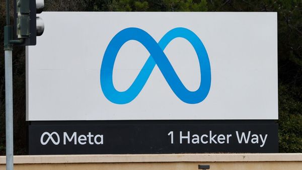 A photo shows Meta's 1 Hacker Way sign in Menlo Park, California, during the daytime.