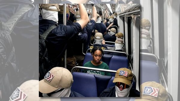 Image shows a Black woman in the Washington D.C. metro surrounded by members of white nationalist group Patriot Front.