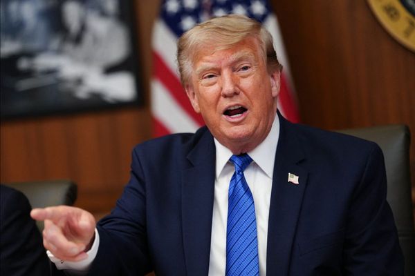 A photo shows President Donald Trump pointing away from the camera.