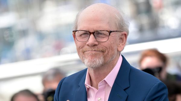Actor and director Ron Howard wearing glasses and a suit.