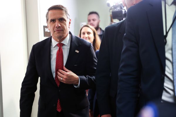 Attorney General Nominee Todd Blanche, an older middle-aged man wearing a suit leaves a meeting while followed by several reporters and camera. 