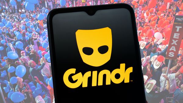 The Grindr logo, a yellow mask featuring the app's name in yellow text, on a black phone screen background, is overlaid on a background of Republican National Convention attendees.