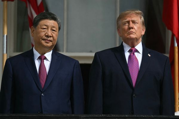 Presidents Xi Jinping of China and Donald Trump of the U.S. Both men wear black suits with reddish-purple ties.
