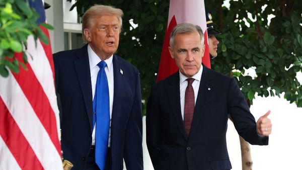Two men, Donald Trump and Mark Carney, stand side by side for a photo posed next to the United States and Canadian flags.